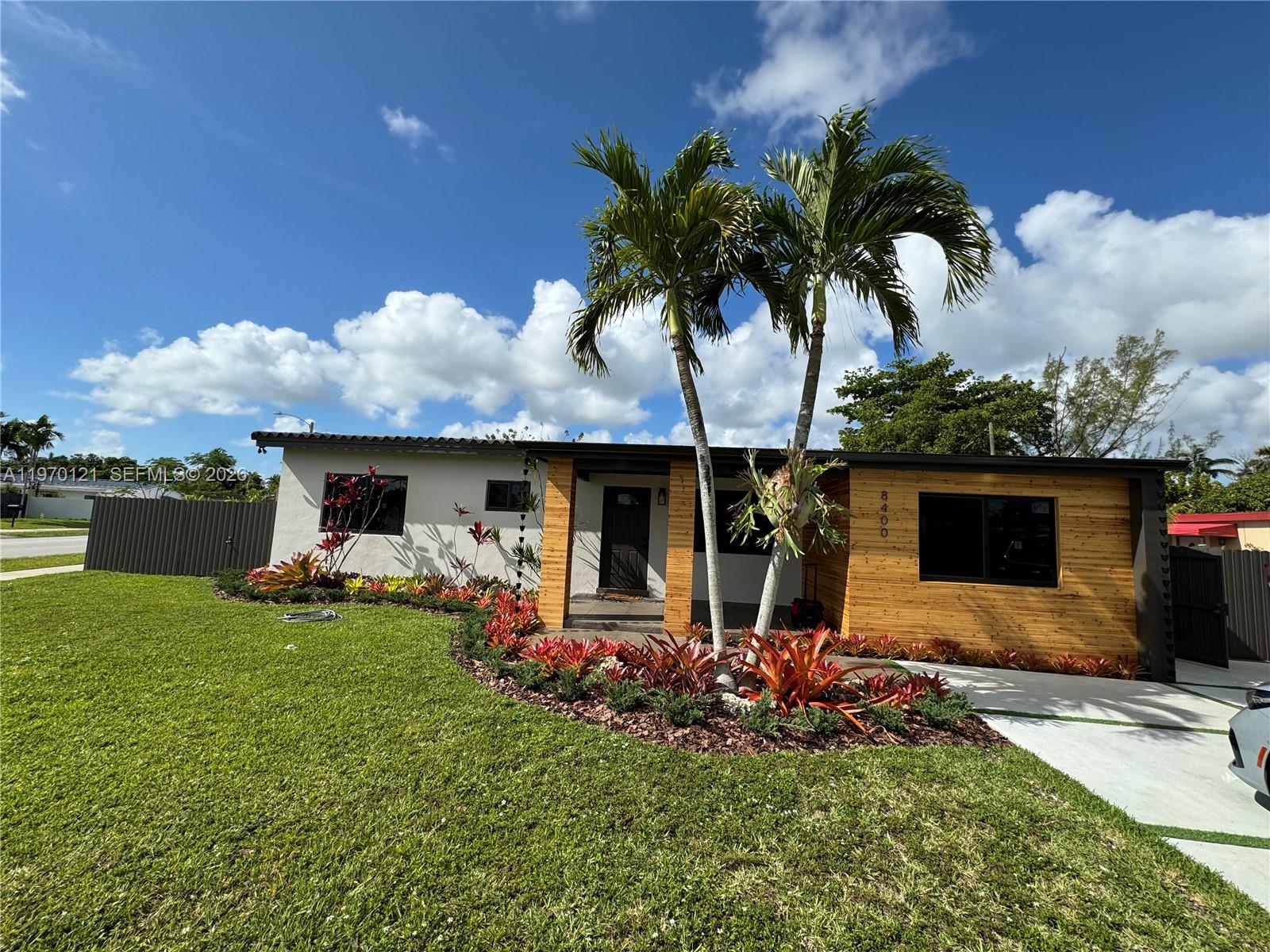 8400 Southwest 46th Street Miami, FL 33155 - Photo 2 of 12 a front view of a house with garden