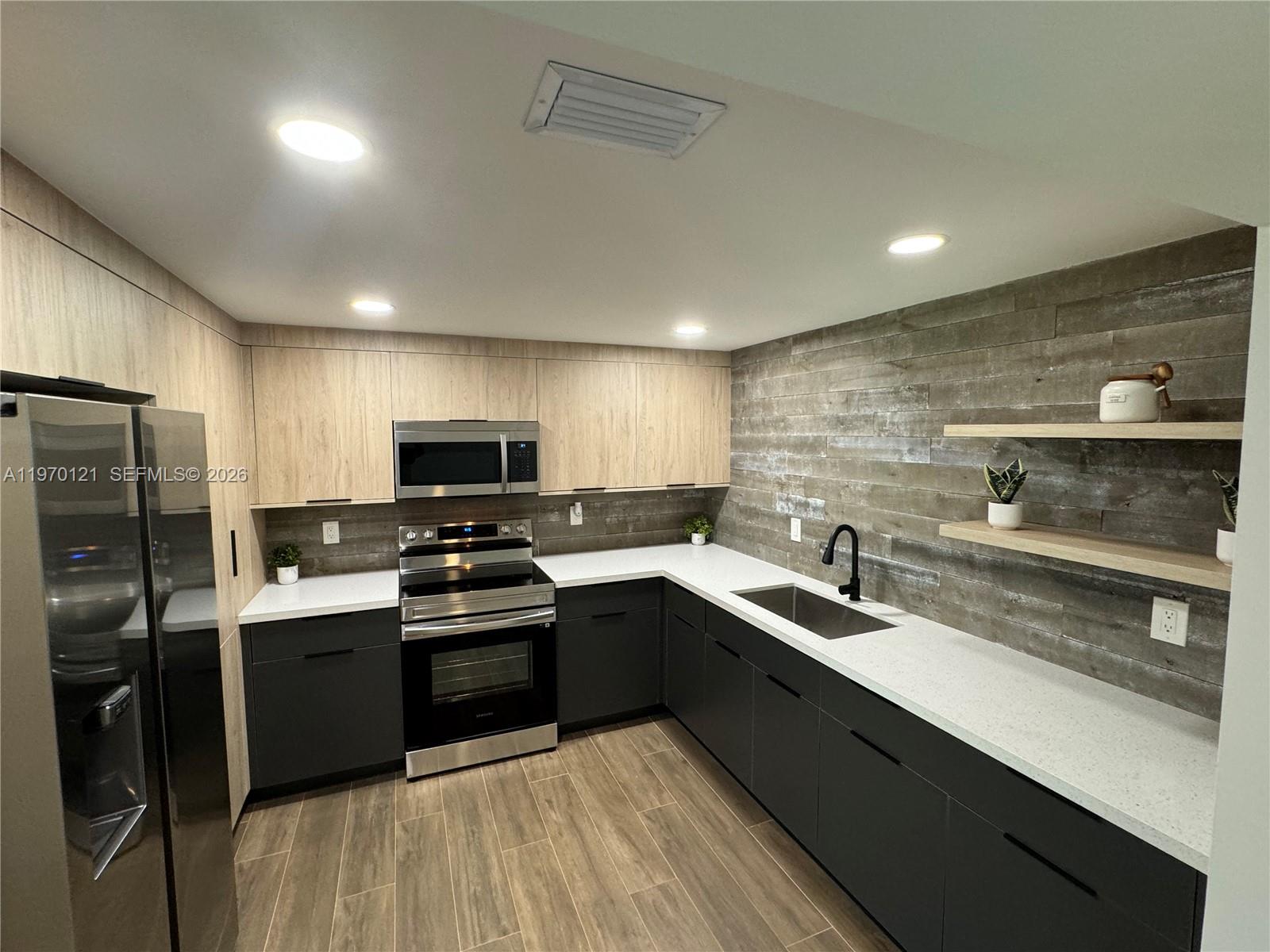 8400 Southwest 46th Street Miami, FL 33155 - Photo 7 of 12 a kitchen with a sink stainless steel appliances and cabinets