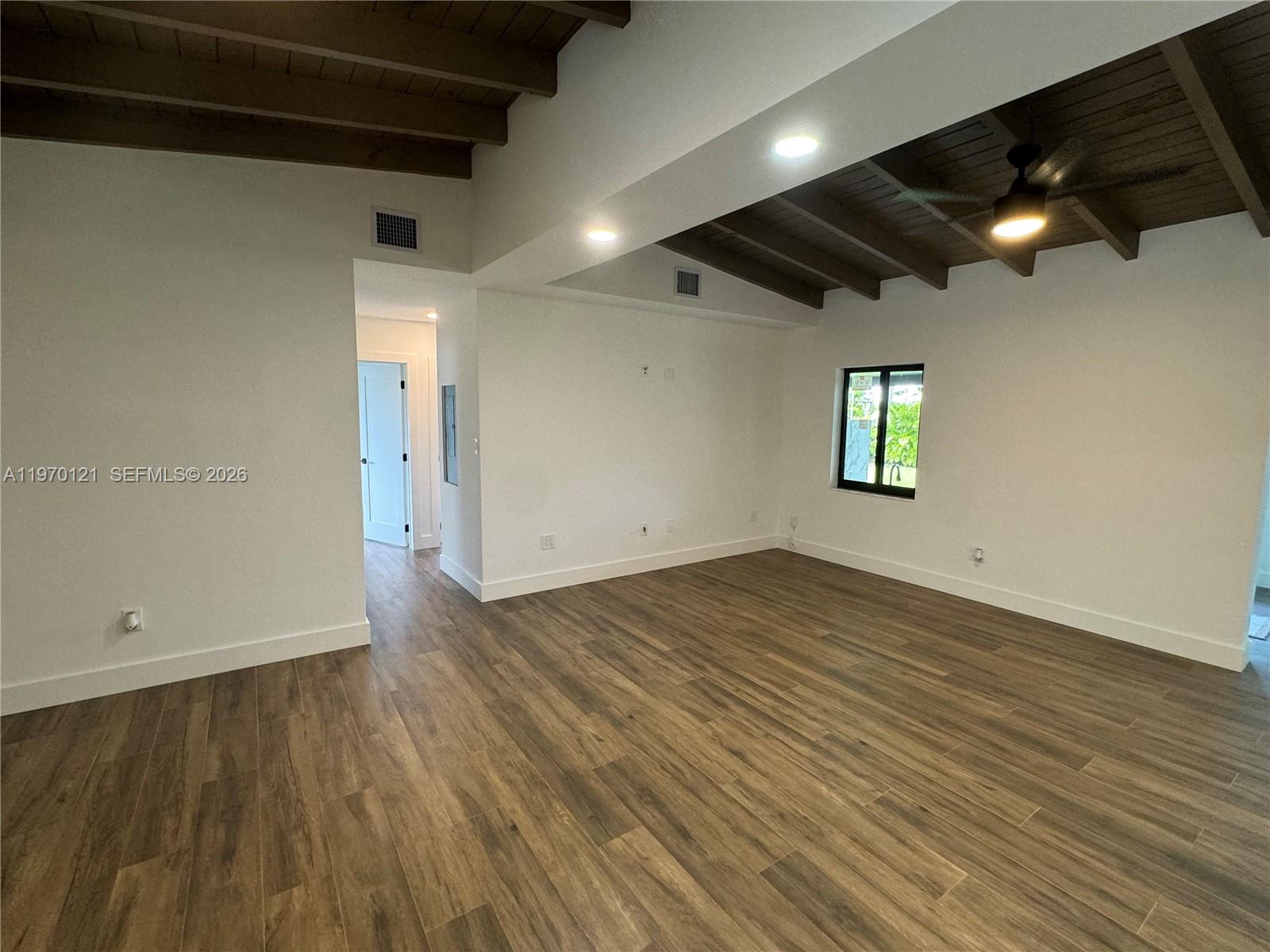 8400 Southwest 46th Street Miami, FL 33155 - Photo 10 of 12 an empty room with wooden floor and windows