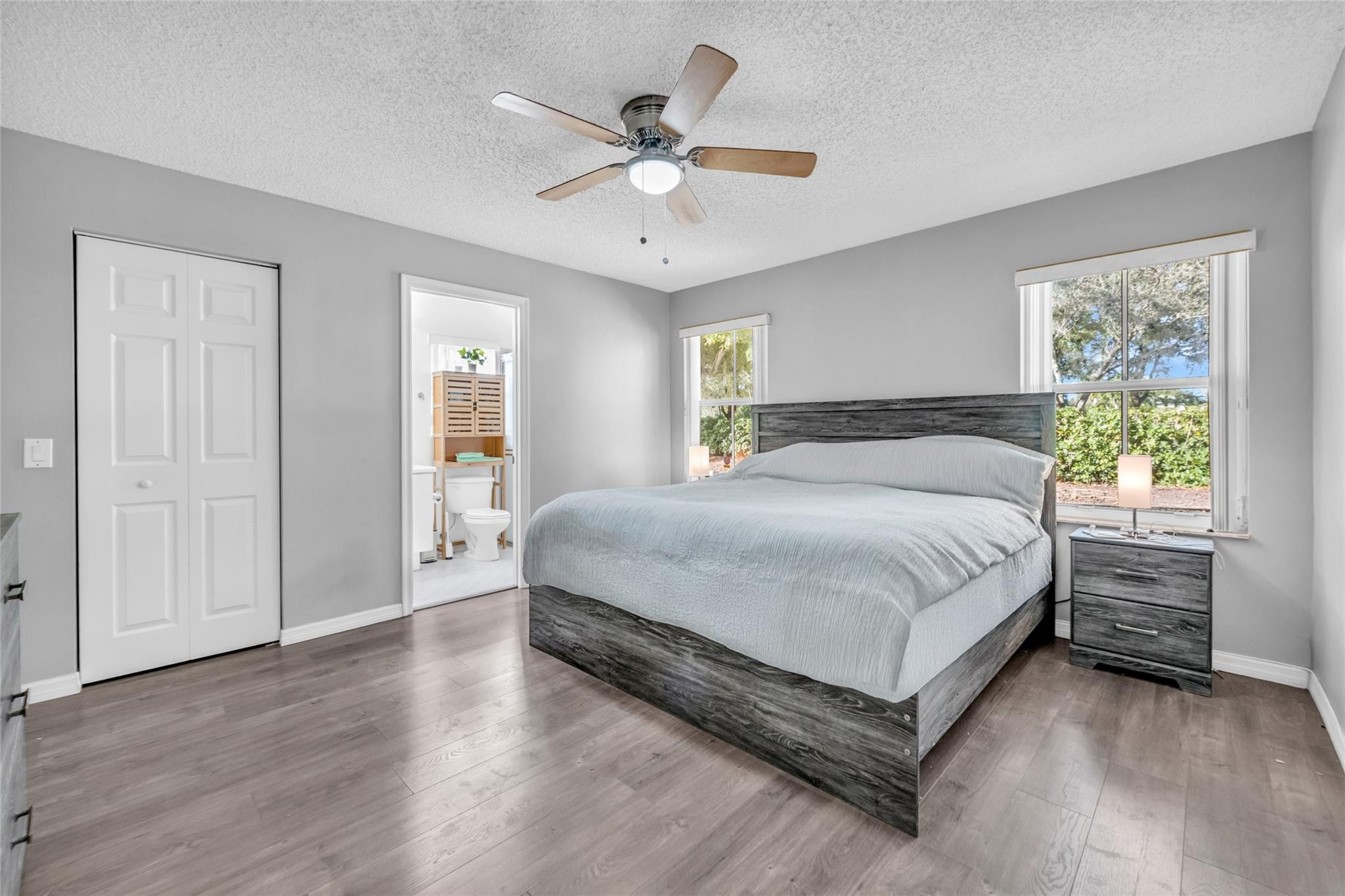 1665 Zenith Way Weston, FL 33327 - Photo 14 of 22 a spacious bedroom with a bed and a ceiling fan