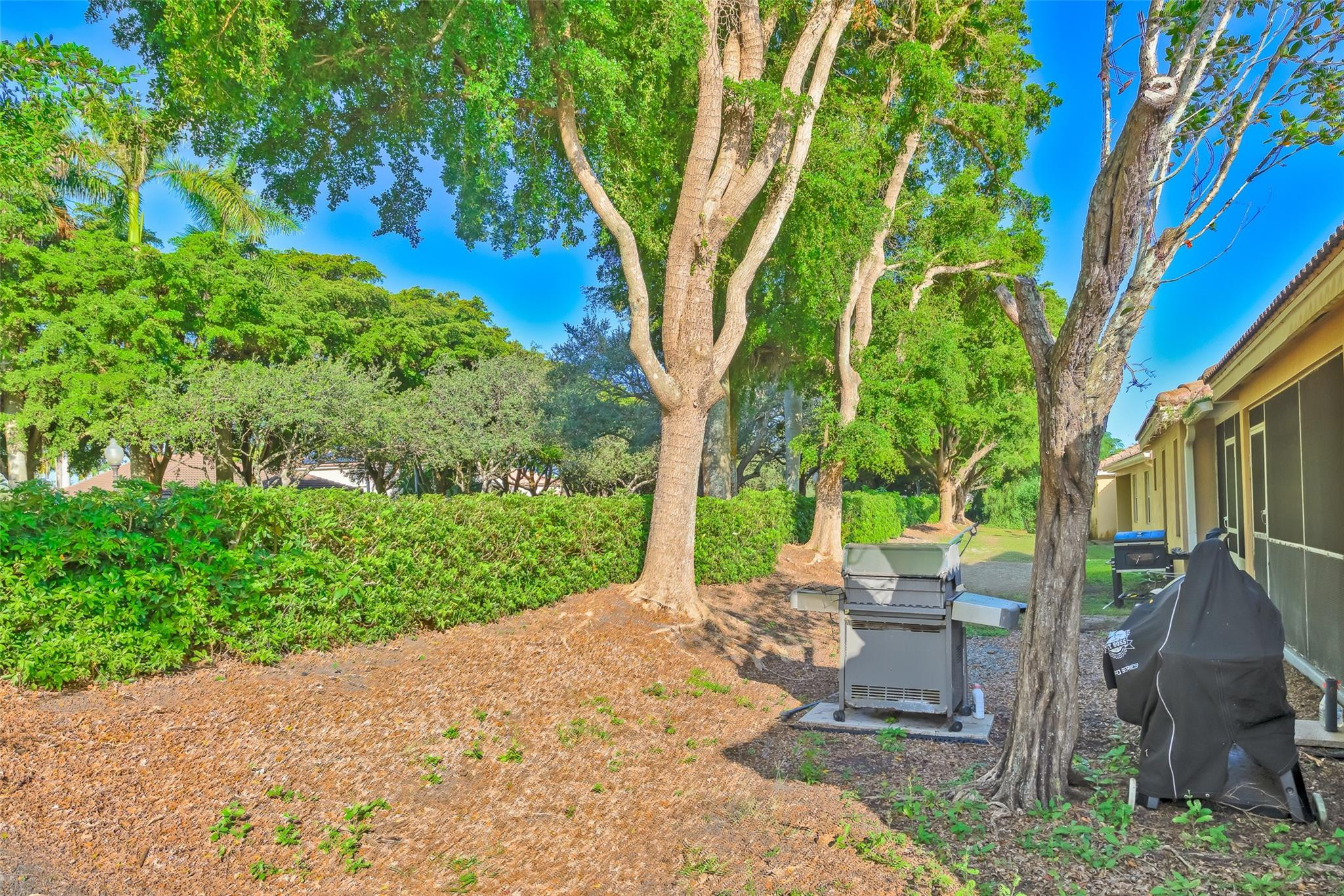 1665 Zenith Way Weston, FL 33327 - Photo 17 of 22 a view of a backyard with table and chairs and potted plants