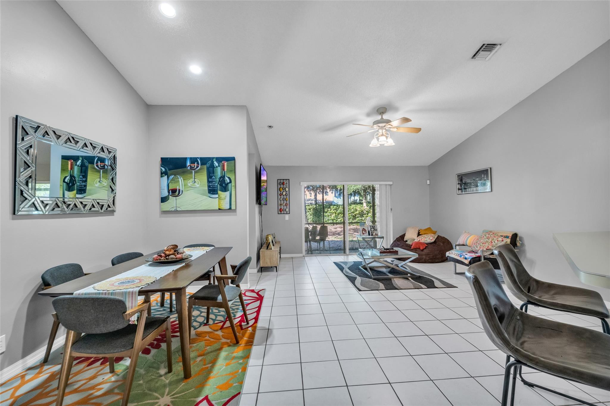 1665 Zenith Way Weston, FL 33327 - Photo 3 of 22 a living room with furniture a chandelier and a dining table