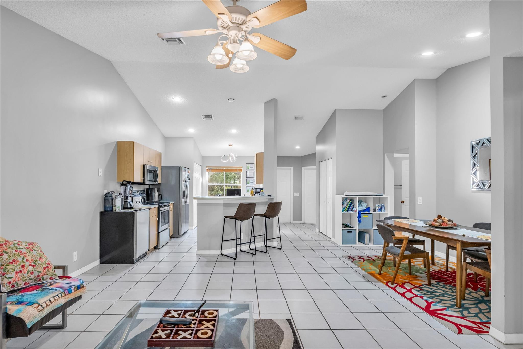 1665 Zenith Way Weston, FL 33327 - Photo 10 of 22 a living room with lots of furniture and kitchen view
