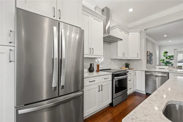 a kitchen with stainless steel appliances a refrigerator sink and cabinets