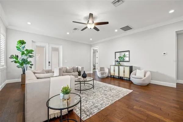 a living room with furniture potted plant and a chandelier
