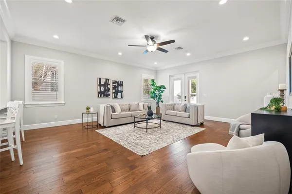 a living room with furniture and wooden floor