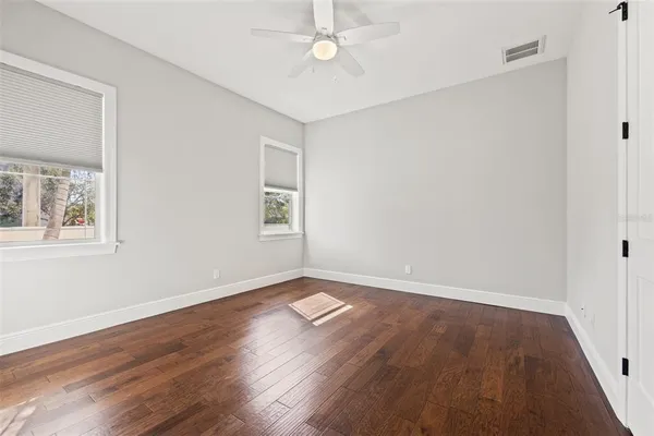 wooden floor in an empty room with a window