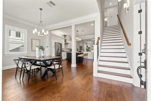 a view of a dining room with furniture and wooden floor