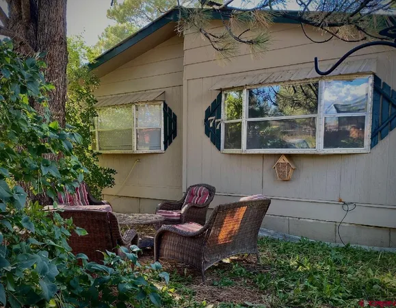 a view of backyard with outdoor seating and plants