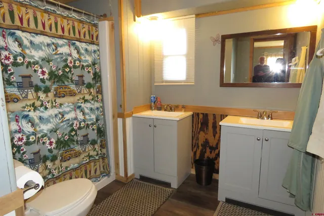 a bathroom with a sink and mirror with toilet
