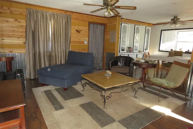 a living room with furniture a table and a chandelier