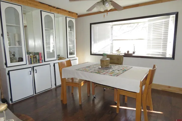 a view of a dining room with furniture and window