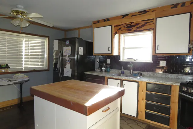 a kitchen with a stove a sink and a refrigerator