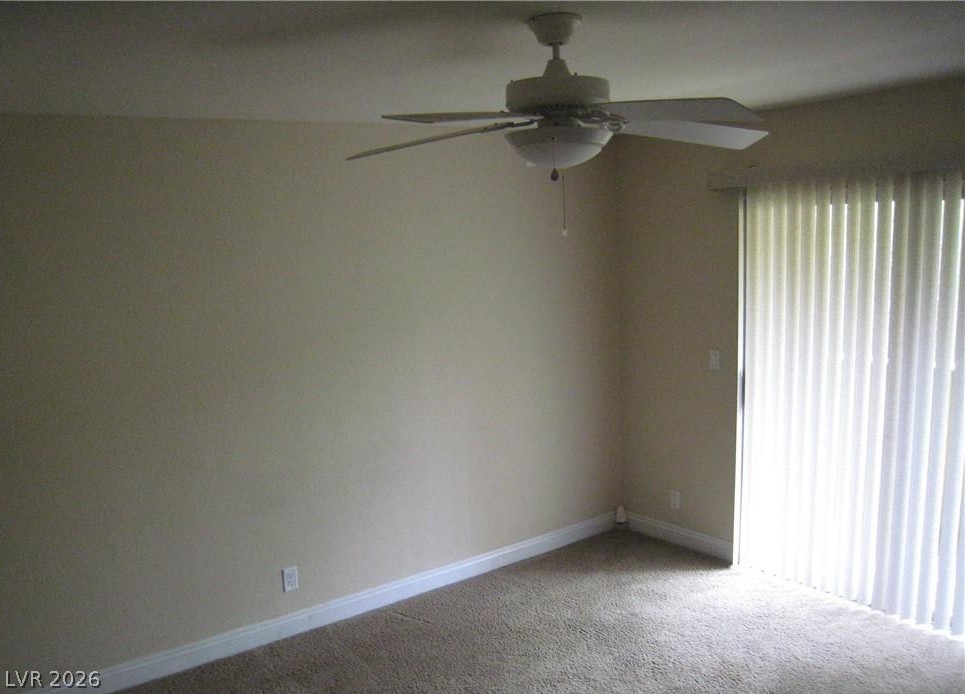 1844 North Decatur Boulevard, Unit 204 Las Vegas, NV 89108 - Photo 8 of 8 A comfortable bedroom with carpet flooring and direct access to outdoor spaces.