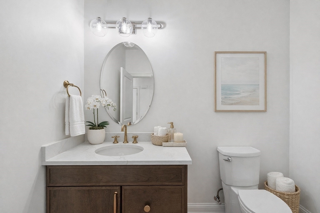 206 West Main Street, Unit 9 Georgetown, MA 01833 - Photo 8 of 25 a bathroom with a toilet sink and mirror