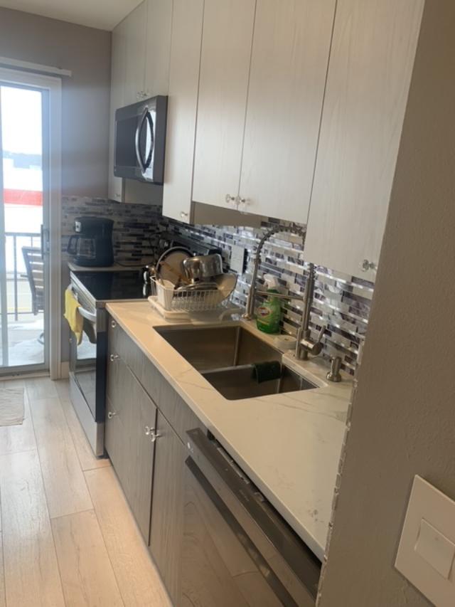 8620 Waukegan Road, Unit 308 Morton Grove, IL 60053 - Photo 2 of 10 a kitchen with a sink and a stove top oven