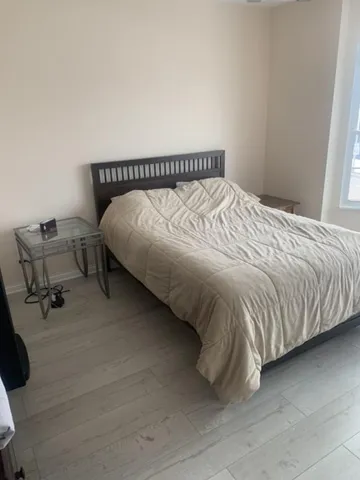 a bedroom with a bed and chair