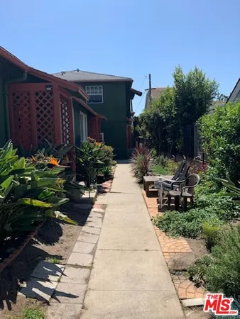a view of a house with potted plants