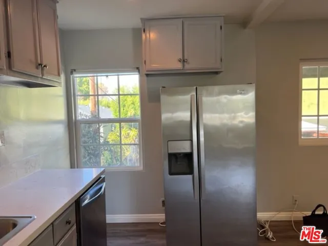 a kitchen with a refrigerator and window