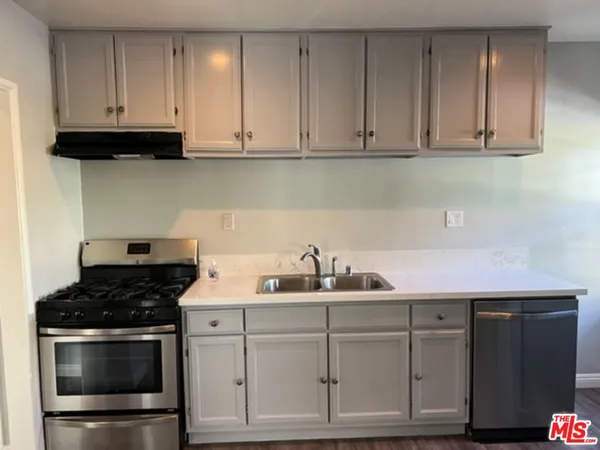 a kitchen with white cabinets and a stove