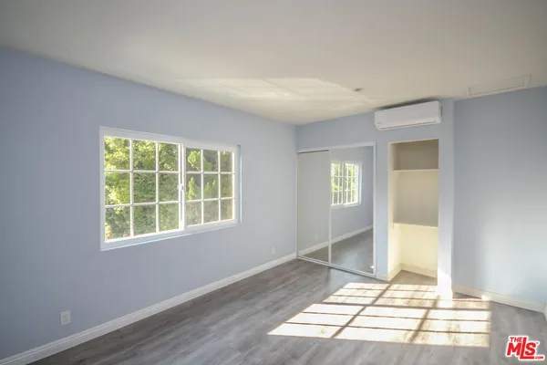 a view of an empty room with glass door