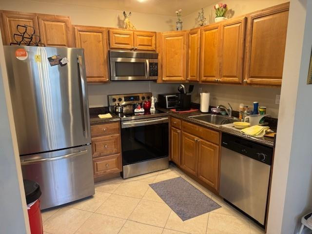 a kitchen with stainless steel appliances granite countertop a refrigerator stove and microwave