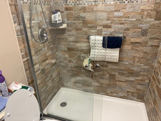 522 Flanders P, Unit 522 Delray Beach, FL 33484 - Photo 11 of 11 a bathroom with a shower and mirror