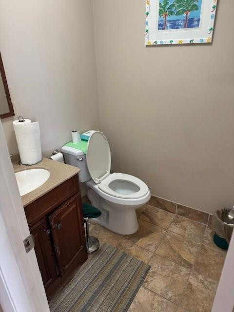 522 Flanders P, Unit 522 Delray Beach, FL 33484 - Photo 3 of 11 a white toilet sitting next to a bathroom sink and vanity