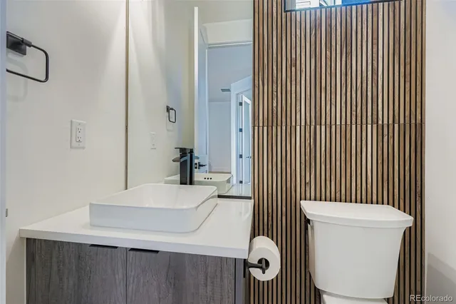 a bathroom with a sink a toilet and mirror
