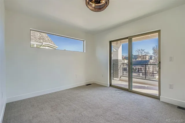 a view of an empty room with glass door