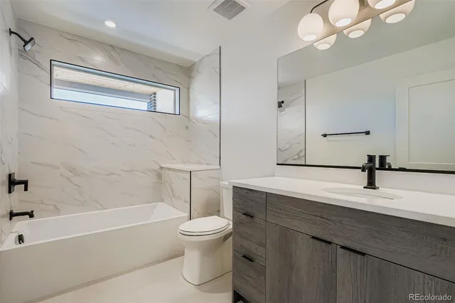a bathroom with a sink a toilet and bathtub