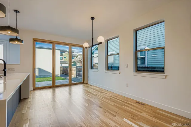 a view of an entryway with wooden floor and windows