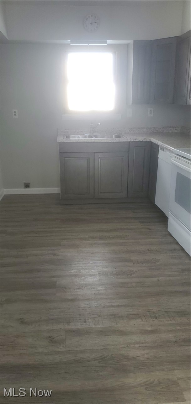 30151 Regent Road Wickliffe, OH 44092 - Photo 5 of 17 Kitchen with dishwasher, dark hardwood / wood-style floors, stove, and sink