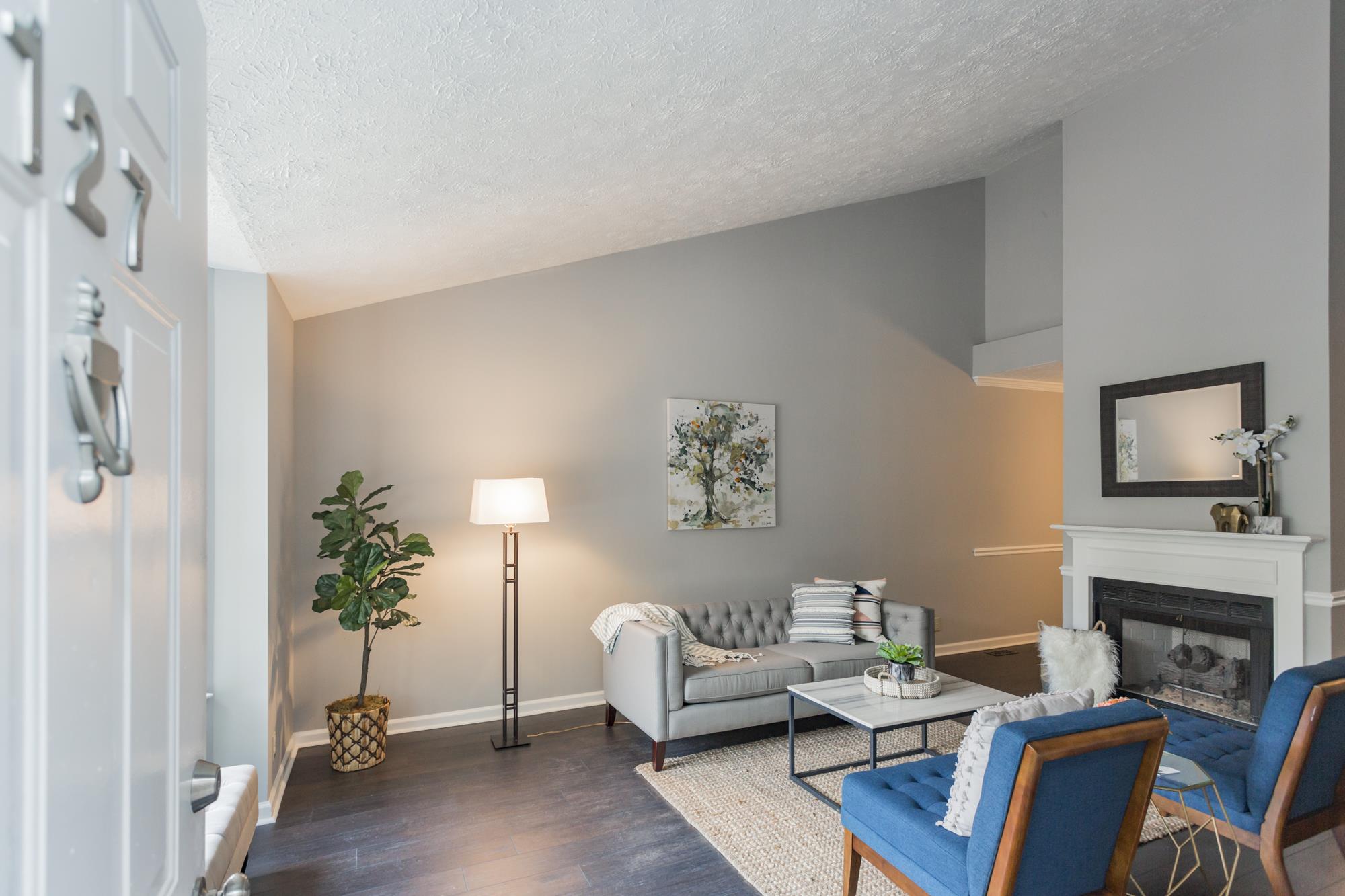 The spacious living room features a vaulted ceiling and fireplace with gas logs.