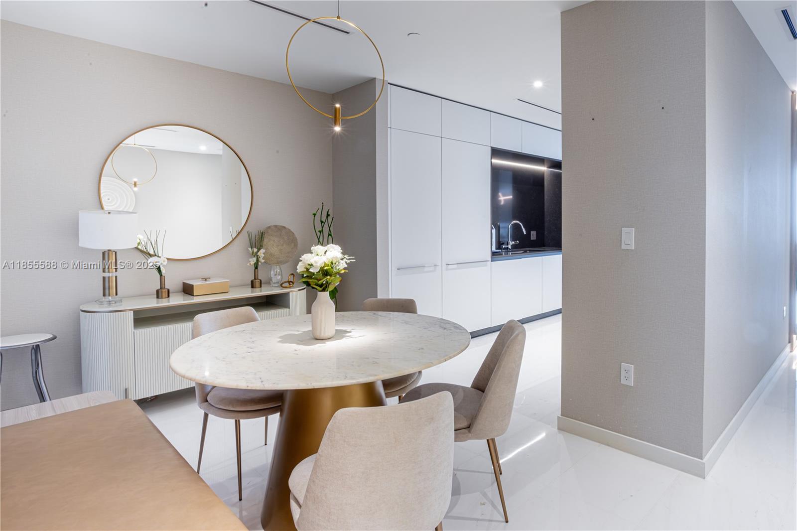 300 Biscayne Blvd Way, Unit 2203C Miami, FL 33131 - Photo 16 of 30 a dining room with furniture and a mirror