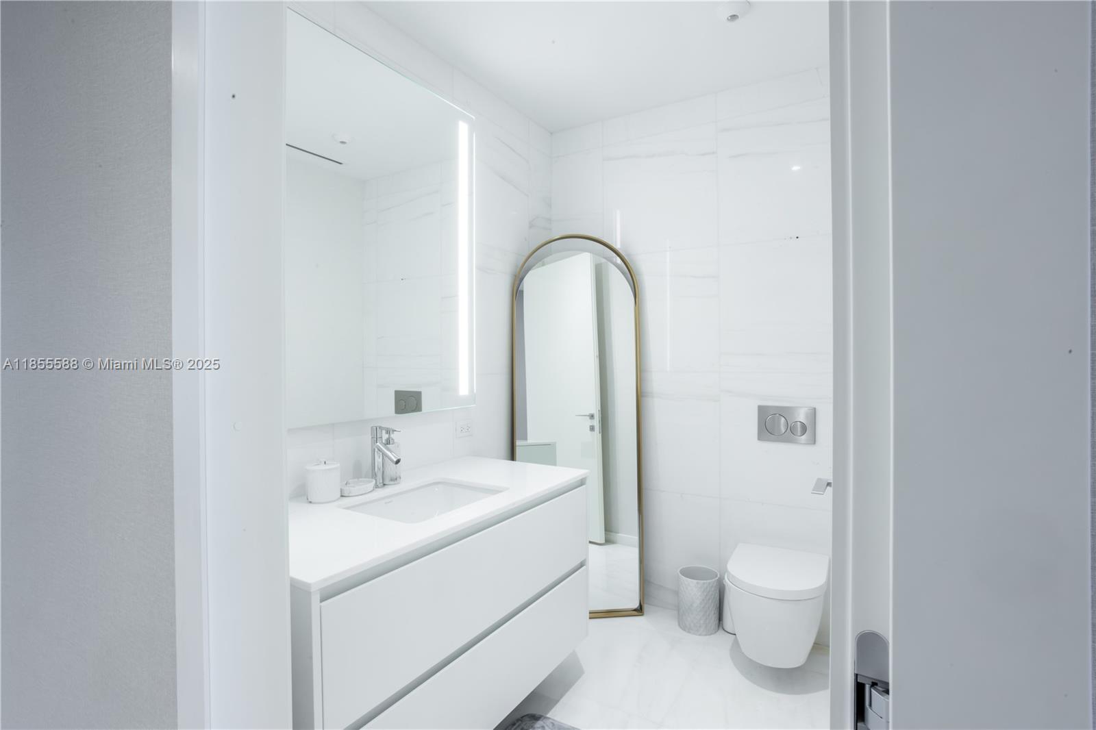 300 Biscayne Blvd Way, Unit 2203C Miami, FL 33131 - Photo 17 of 30 a bathroom with a sink and a toilet