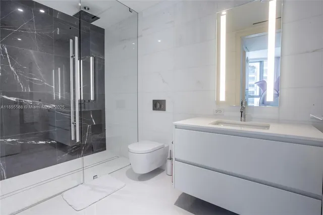 a spacious bedroom with a large bed and a chandelier