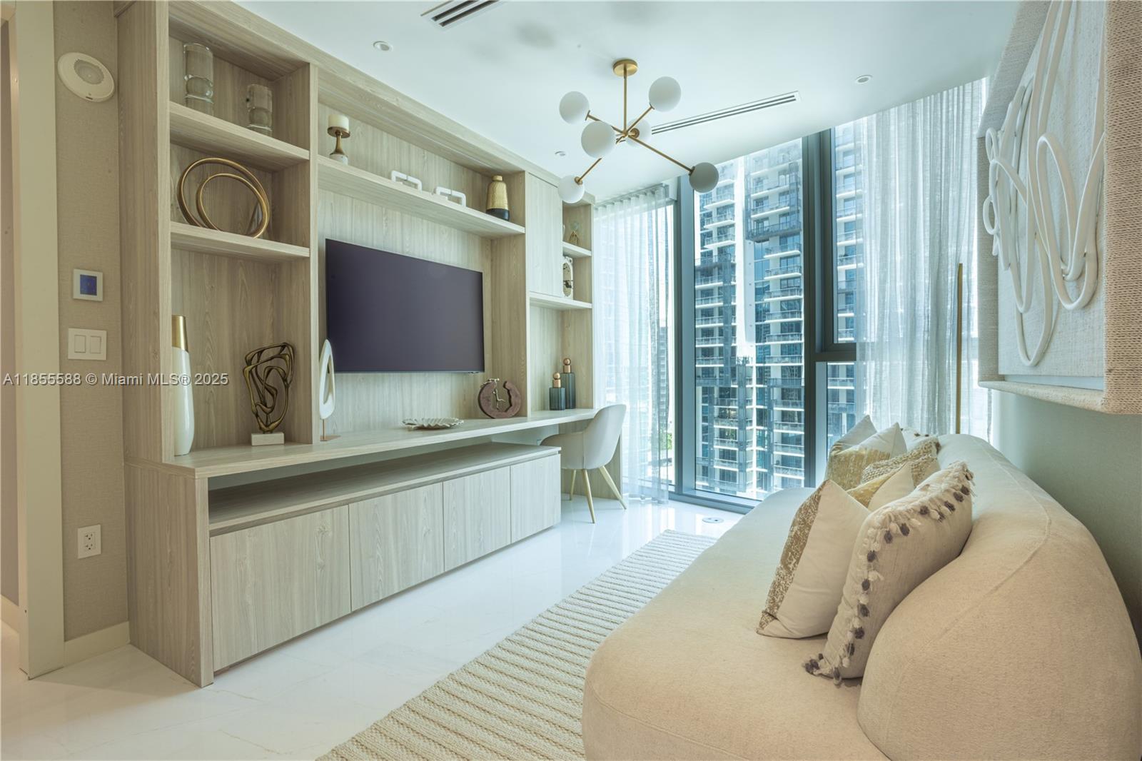 300 Biscayne Blvd Way, Unit 2203C Miami, FL 33131 - Photo 21 of 30 a spacious bedroom with a large bed and a chandelier