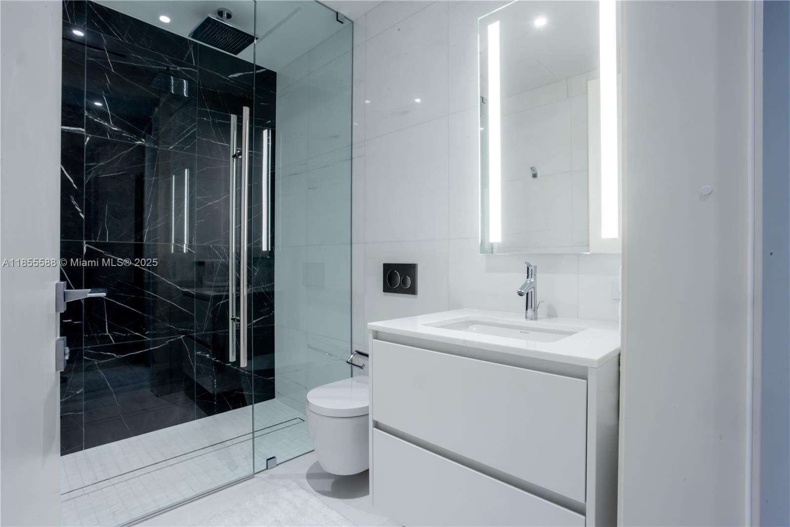 300 Biscayne Blvd Way, Unit 2203C Miami, FL 33131 - Photo 22 of 30 a bathroom with a sink a toilet and shower