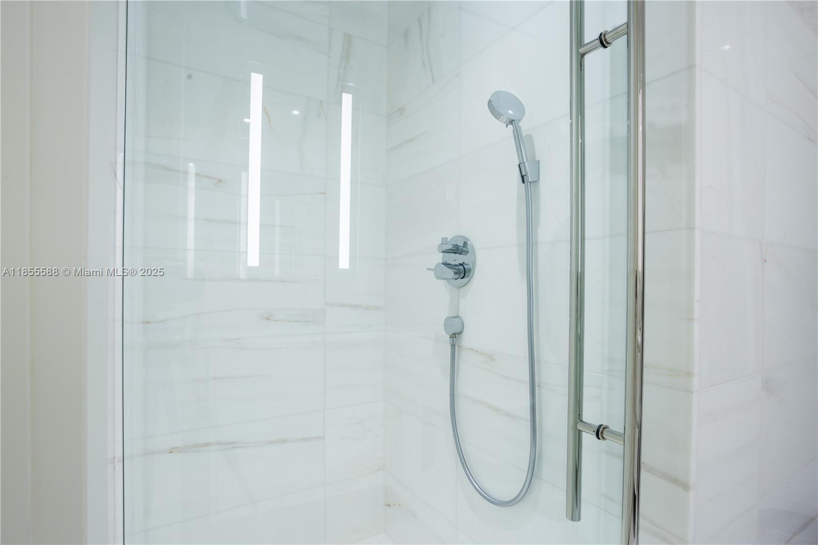 300 Biscayne Blvd Way, Unit 2203C Miami, FL 33131 - Photo 28 of 30 a bathroom with a glass shower door