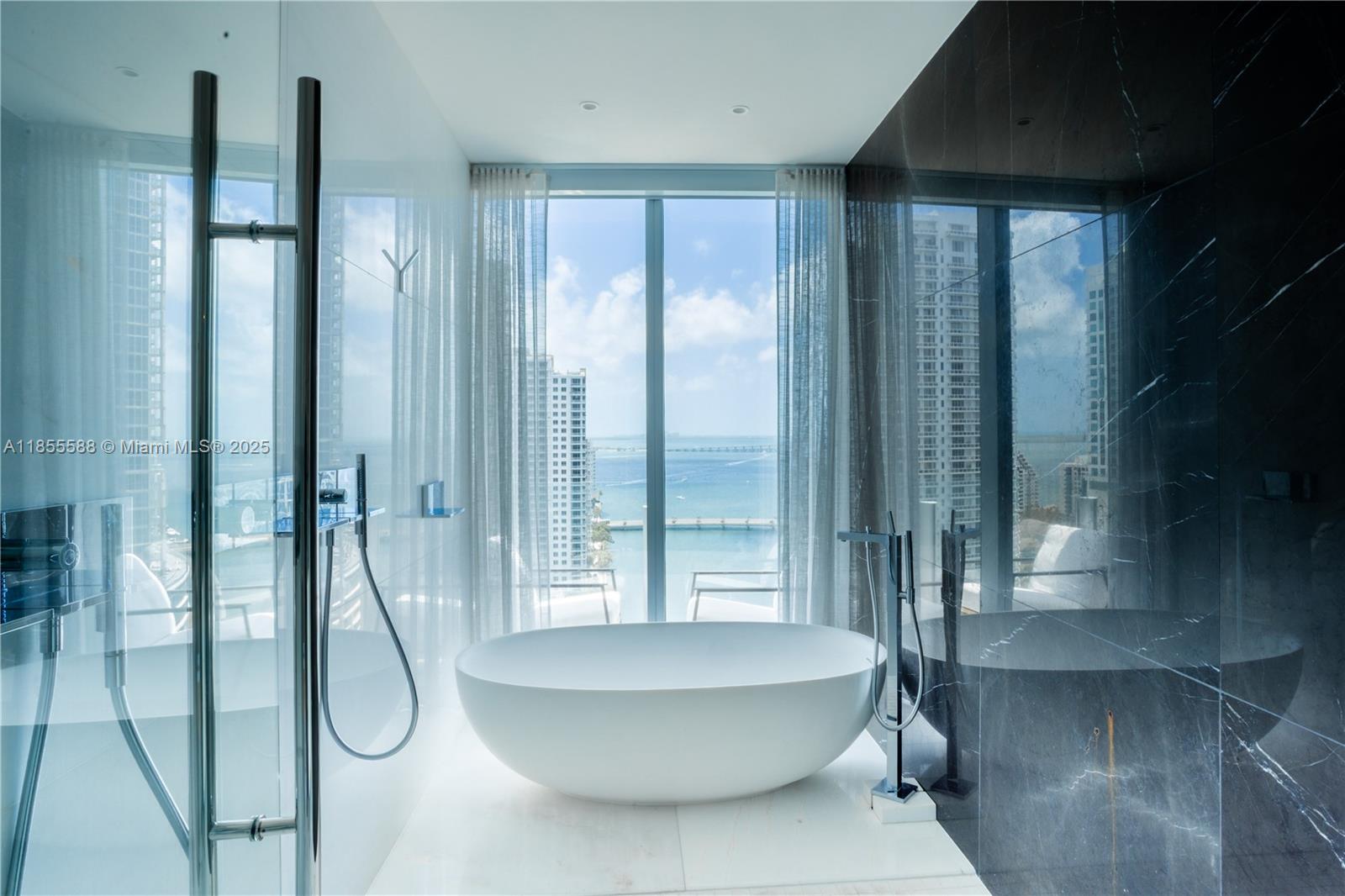 300 Biscayne Blvd Way, Unit 2203C Miami, FL 33131 - Photo 9 of 30 a bathroom with a bathtub and shower