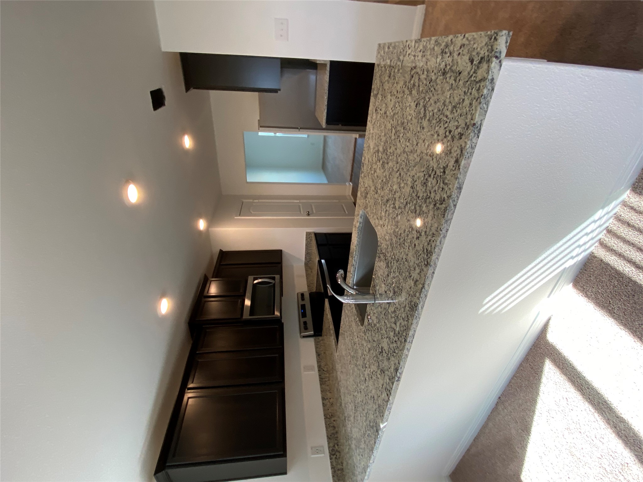 18308 Speculator Lane Elgin, TX 78621 - Photo 12 of 16 a view of kitchen island a sink wooden floor and a living room