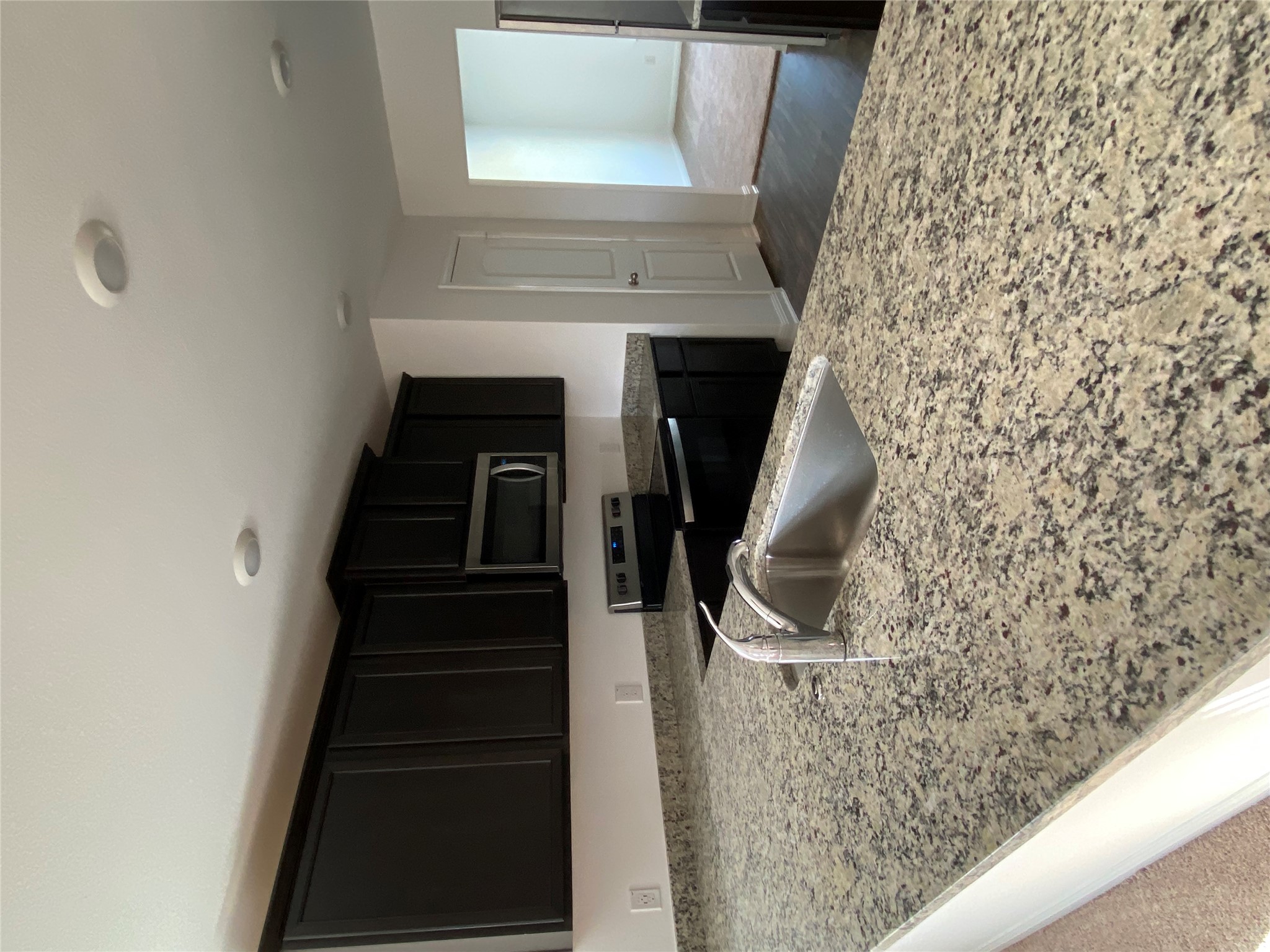 18308 Speculator Lane Elgin, TX 78621 - Photo 2 of 16 a kitchen with granite countertop a sink and a stove top oven