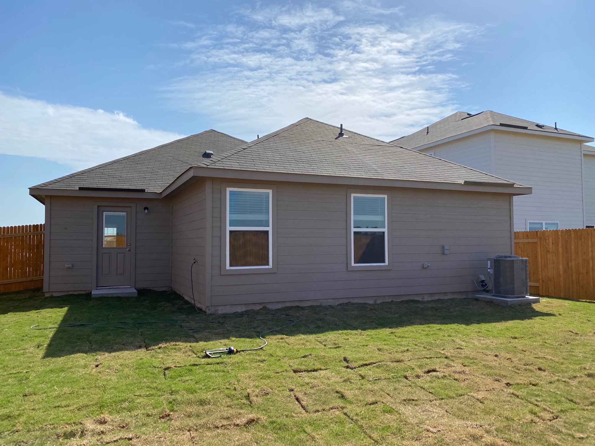18308 Speculator Lane Elgin, TX 78621 - Photo 8 of 16 a front view of a house with a yard