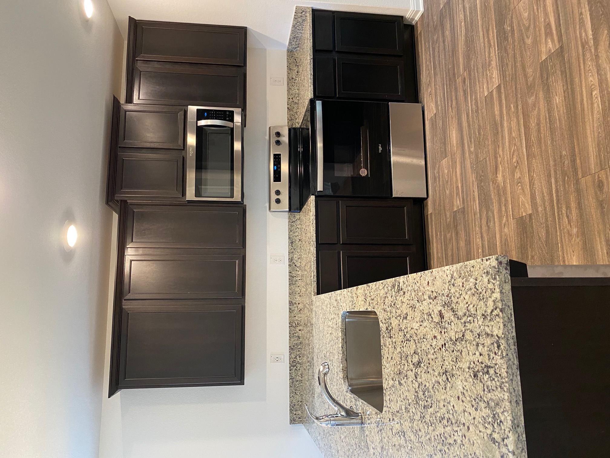 18308 Speculator Lane Elgin, TX 78621 - Photo 9 of 16 a kitchen with stainless steel appliances wooden cabinets and granite counter tops