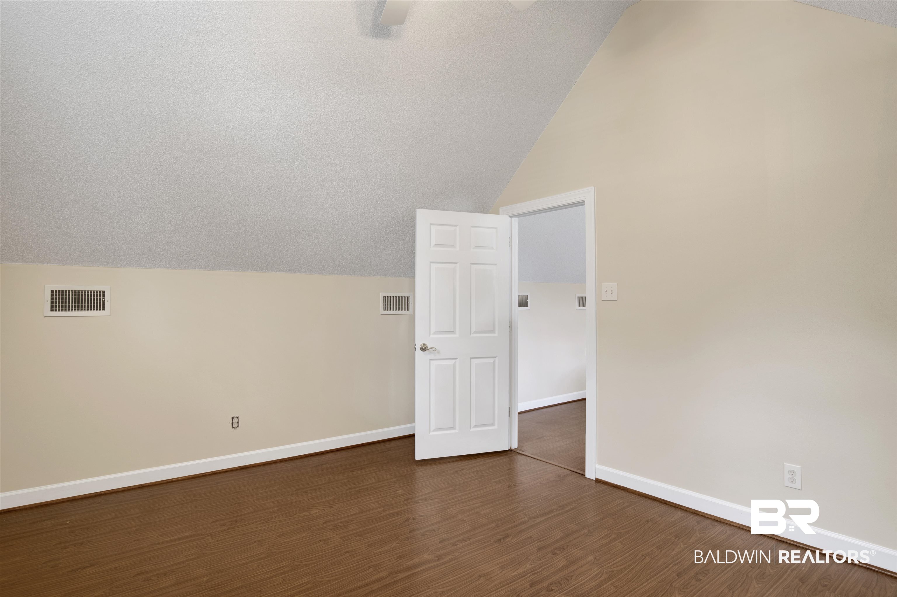 8847 Dawes Lake Road South Mobile, AL 36619 - Photo 31 of 47 Room featuring wood-finish flooring, white baseboards, and neutral wall paint