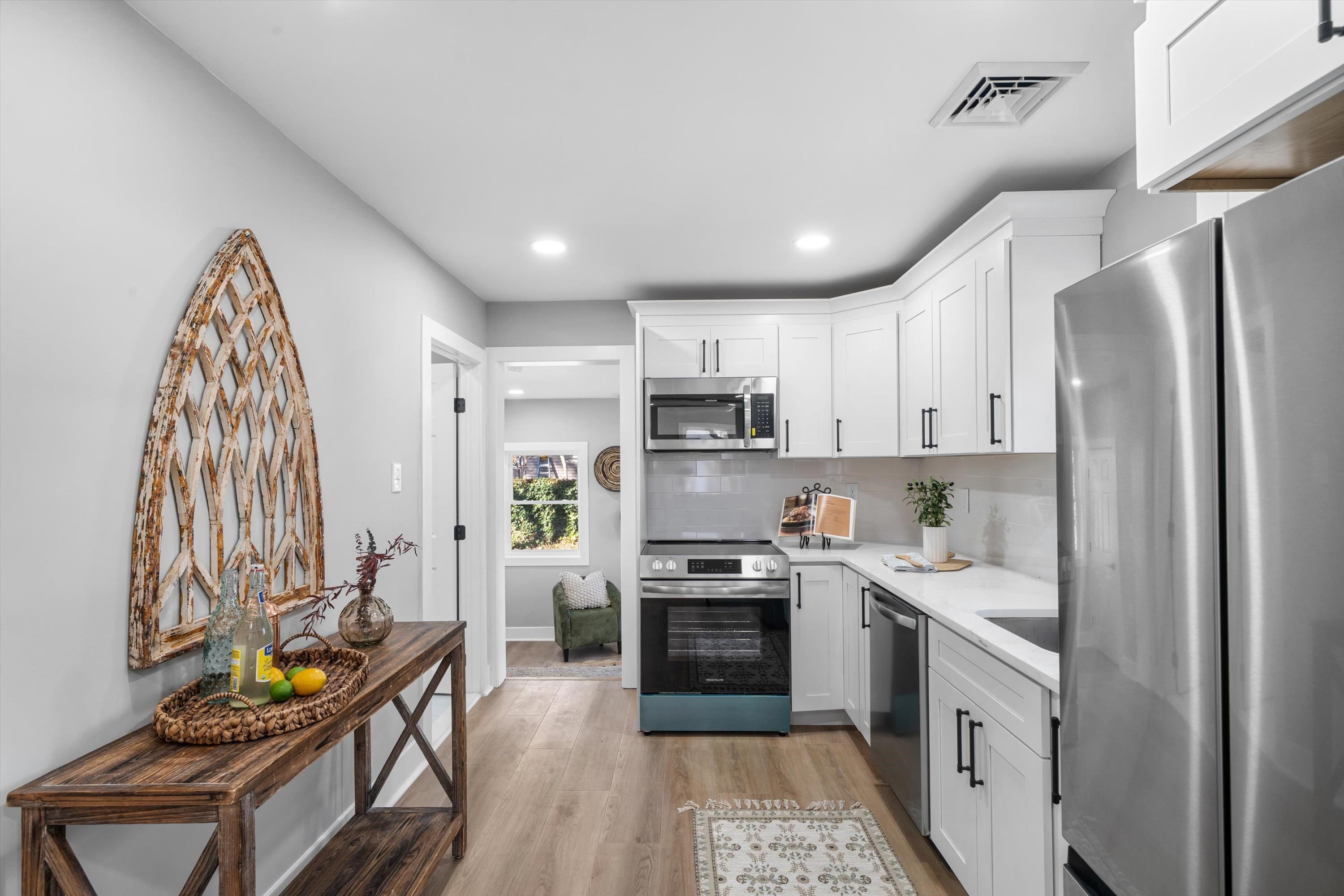 7 Tulip Avenue Villas, NJ 08251 - Photo 9 of 26 a kitchen with stainless steel appliances granite countertop a refrigerator a sink dishwasher a stove and white countertops with wooden floor