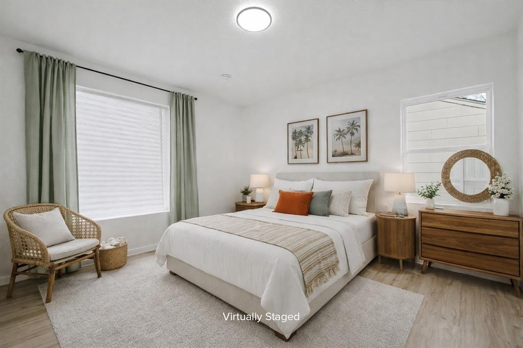 11446 Lippitt Avenue Dallas, TX 75218 - Photo 19 of 26 a bedroom with a bed and a couch