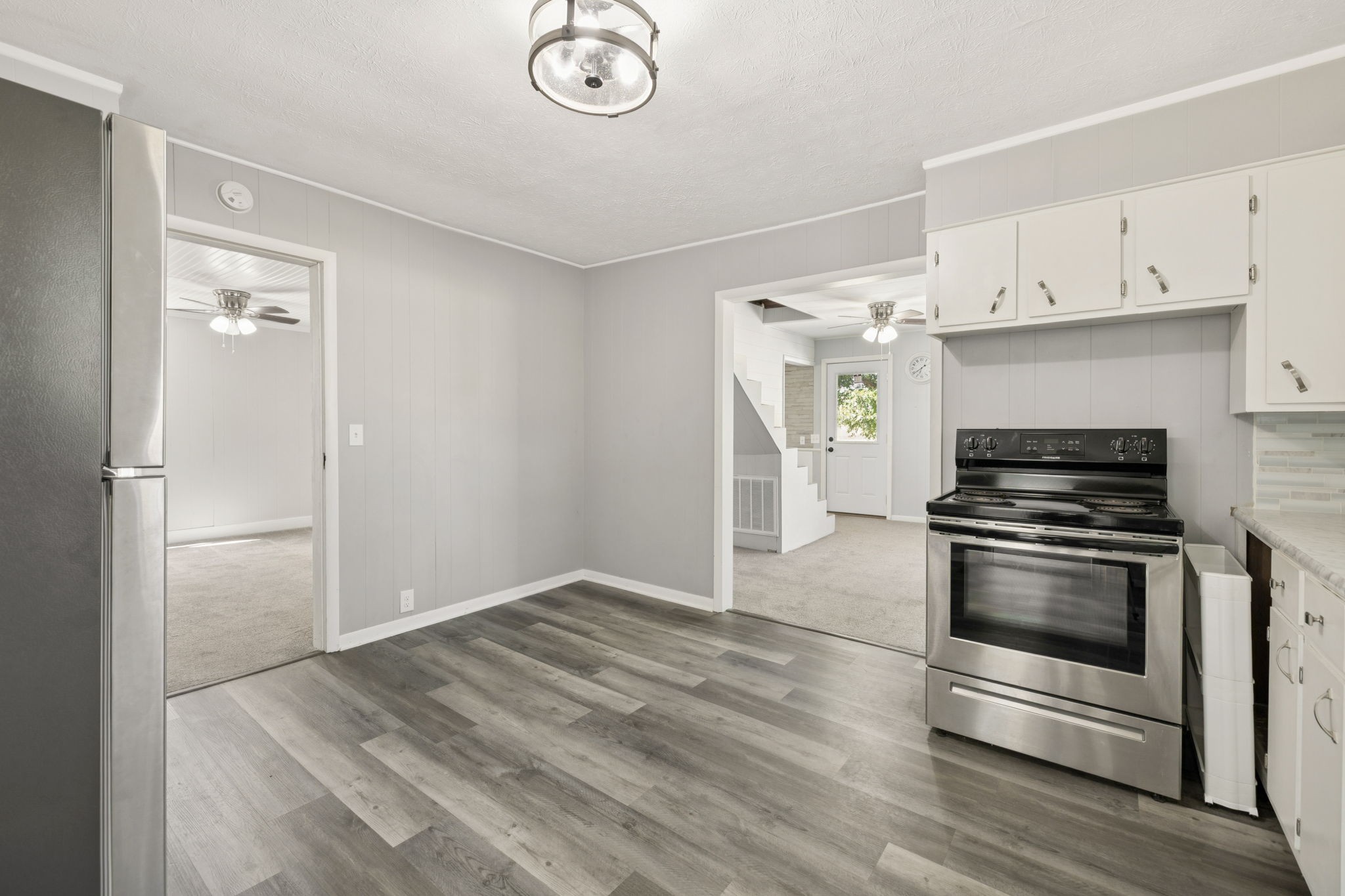 315 Ferguson Hill Road Lafayette, TN 37083 - Photo 16 of 29 a kitchen with granite countertop a refrigerator and a stove top oven