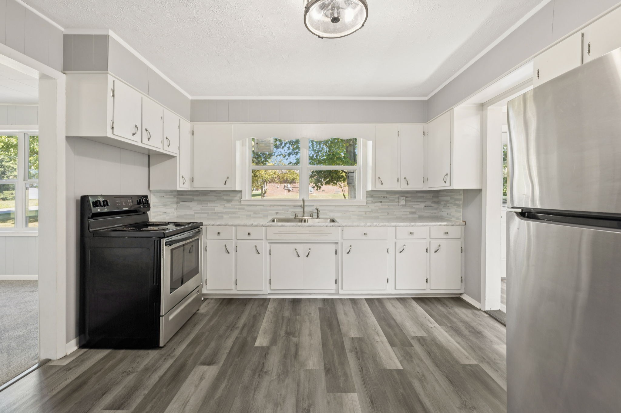 315 Ferguson Hill Road Lafayette, TN 37083 - Photo 17 of 29 a kitchen with a refrigerator stove and white cabinets